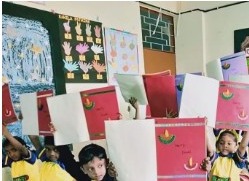 Children displaying art and craft work